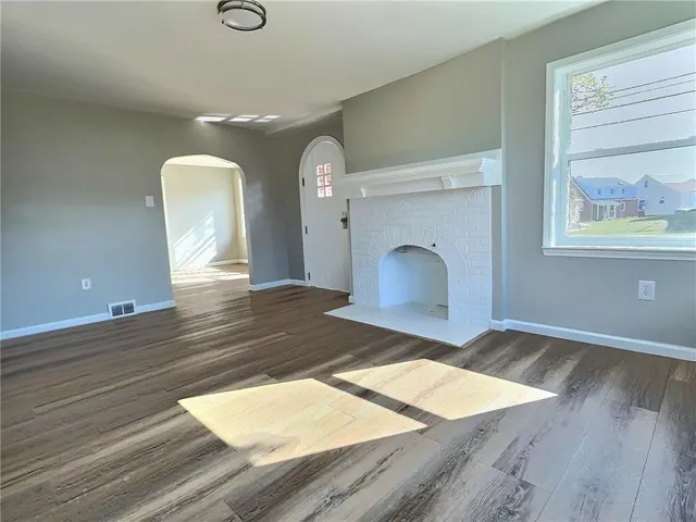 a view of a bedroom with wooden floor and front door