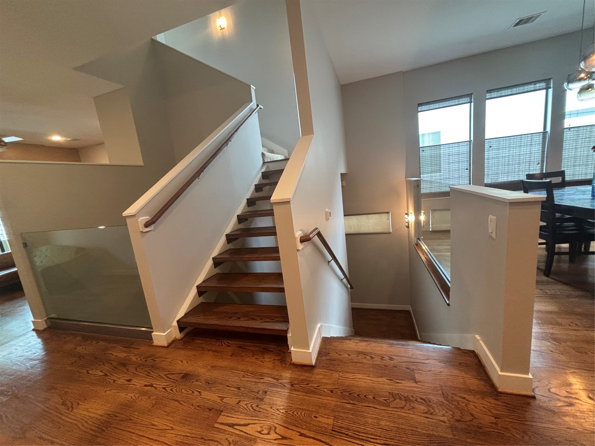 6016 Truro Street Houston, TX 77007 - Photo 7 of 26 Architectural staircase with rich hardwood treads and modern railings, creating a striking focal point within the home's open concept design.