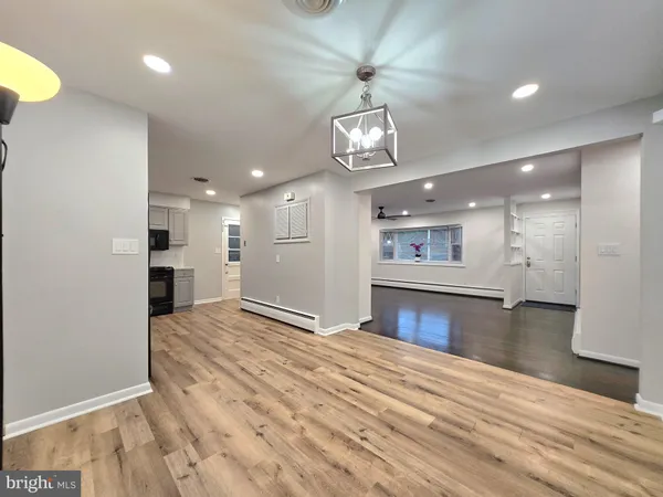 a view of an empty room with wooden floor