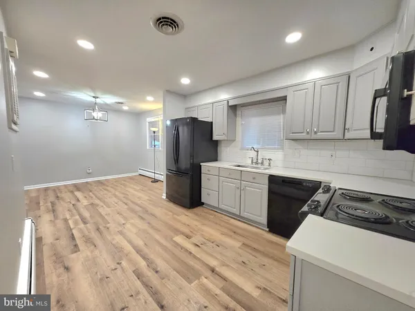 a kitchen with a refrigerator sink and cabinets