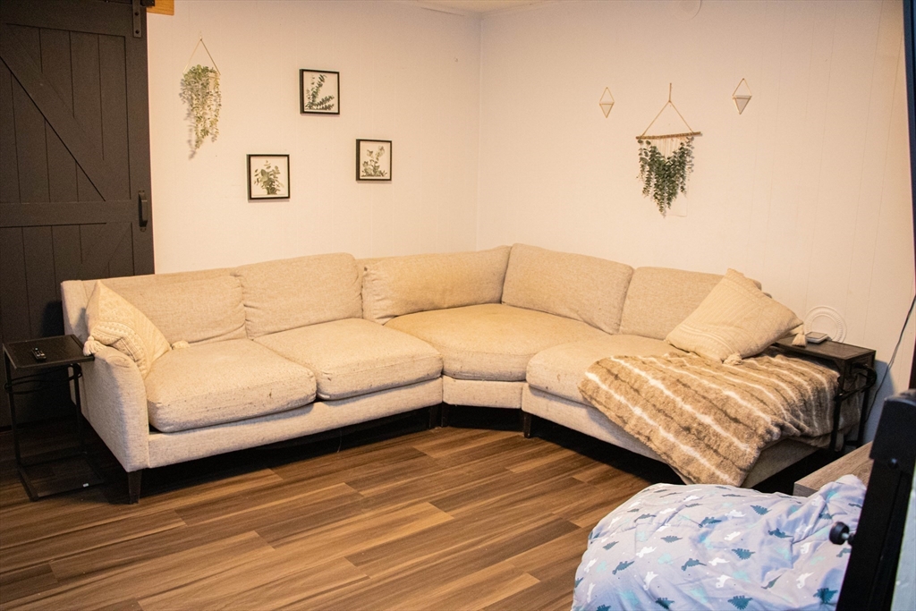 85-87 Slater Street Webster, MA 01570 - Photo 13 of 41 a living room with couches and a night stand