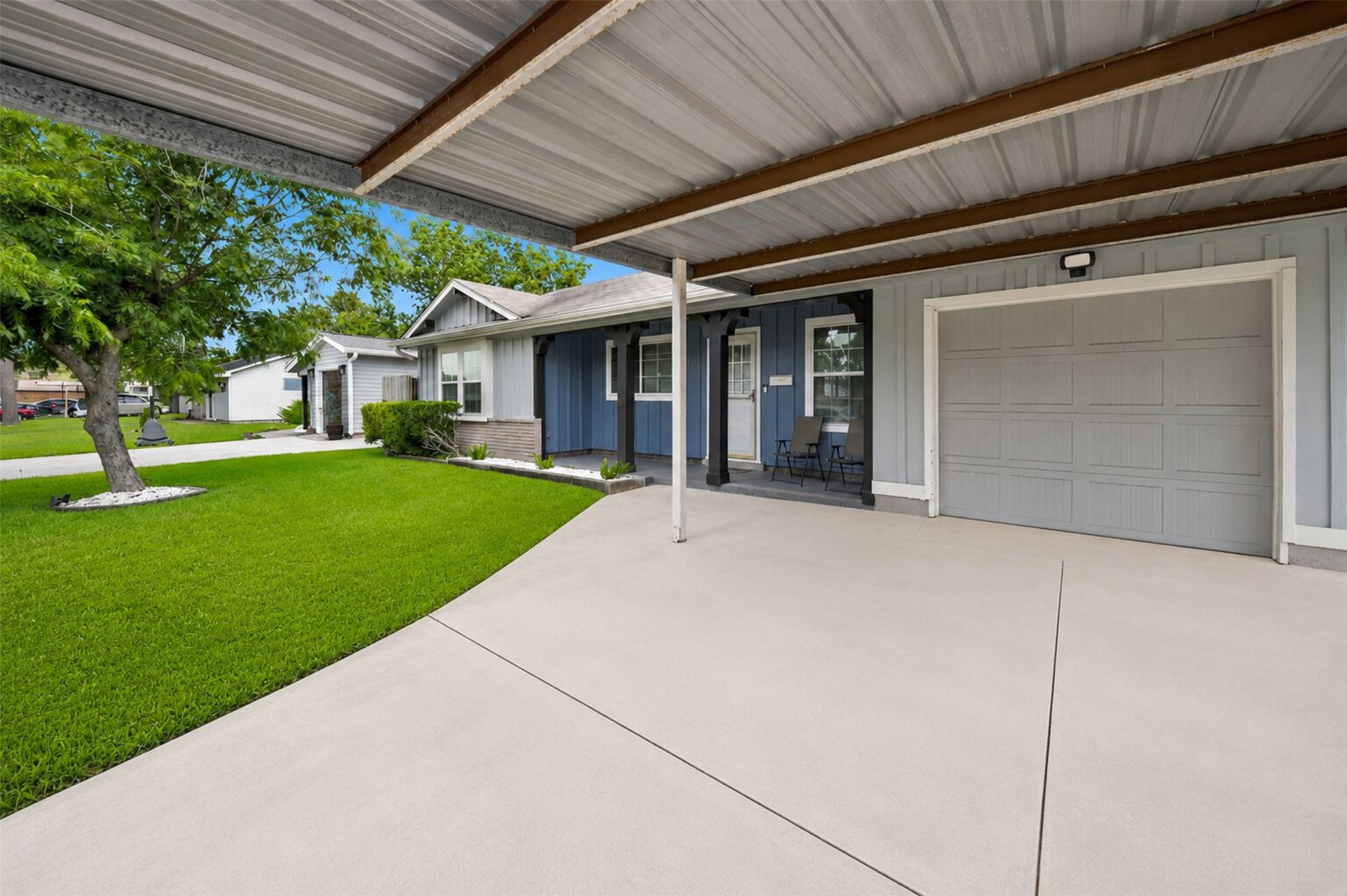 1306 Camden Road Pasadena, TX 77502 - Photo 2 of 16 Generous covered carport with a wide concrete driveway, attached garage, and a welcoming front porch, plenty of covered parking right at your doorstep!