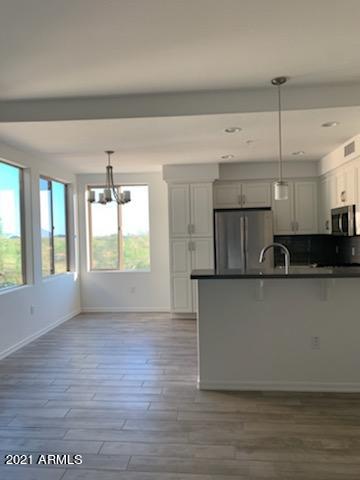 17850 North 68th Street, Unit 2063 Phoenix, AZ 85054 - Photo 11 of 23 a view of kitchen with stainless steel appliances granite countertop a stove a sink a refrigerator and a large window