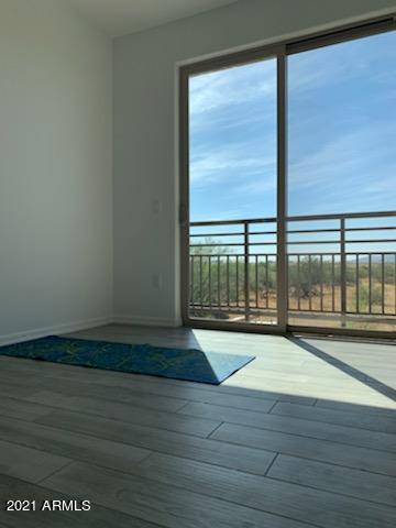 17850 North 68th Street, Unit 2063 Phoenix, AZ 85054 - Photo 13 of 23 a view of empty room with wooden floor and fan