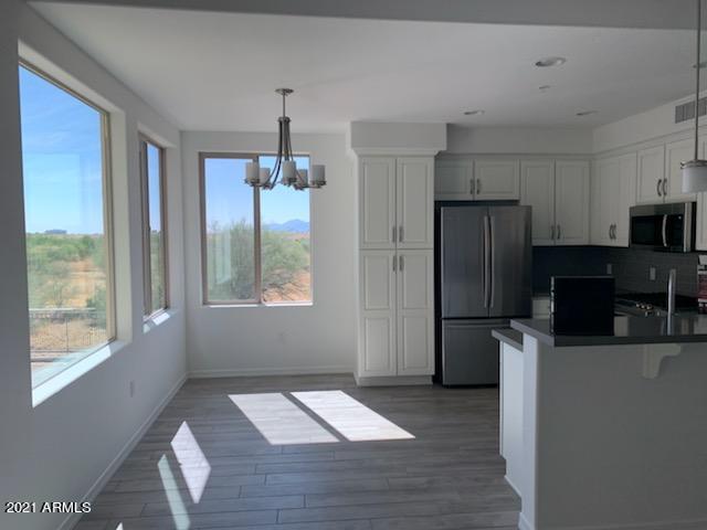 17850 North 68th Street, Unit 2063 Phoenix, AZ 85054 - Photo 14 of 23 a kitchen with a refrigerator a stove a sink and a window