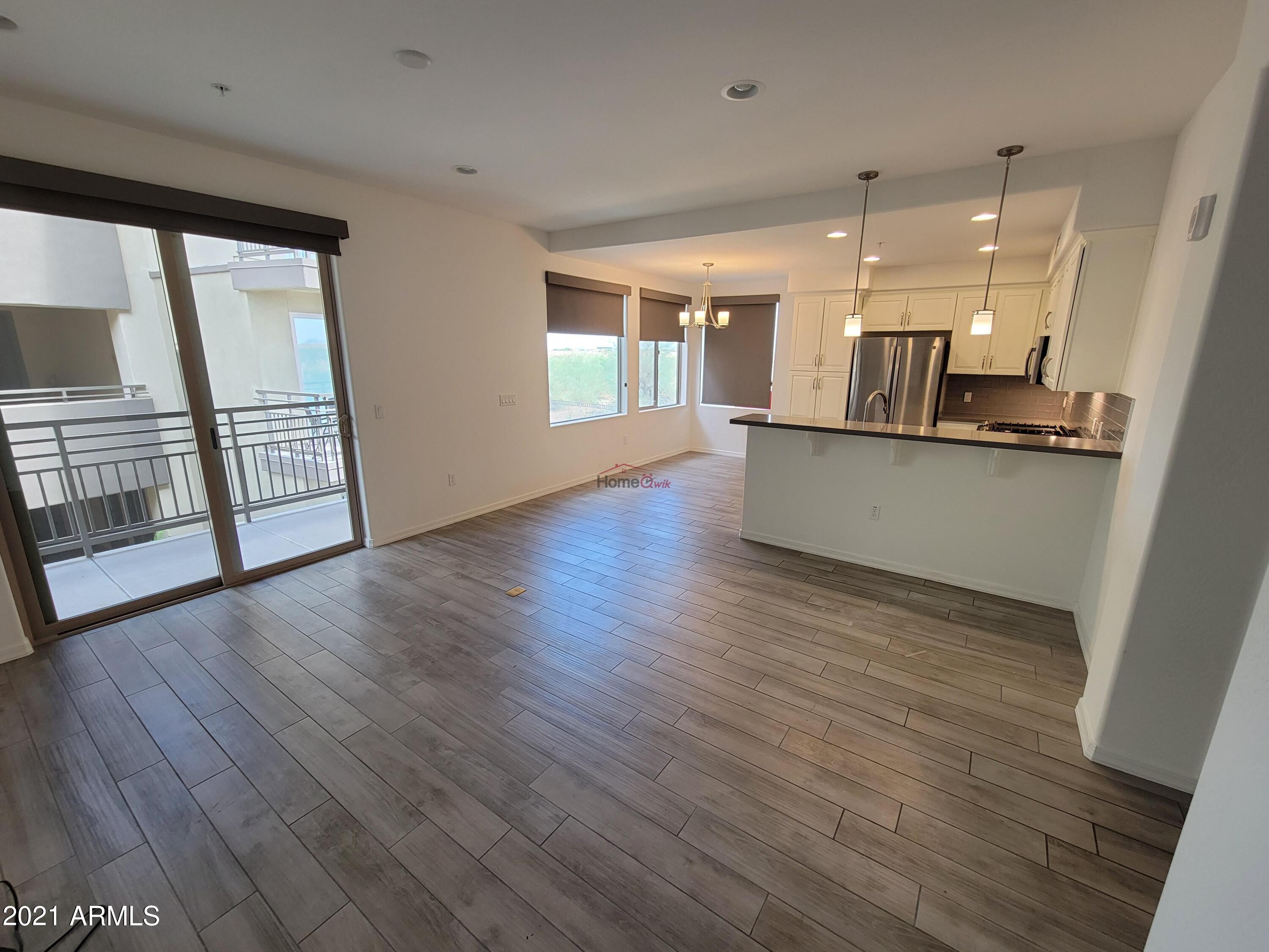17850 North 68th Street, Unit 2063 Phoenix, AZ 85054 - Photo 17 of 23 a view of a kitchen with wooden floor and a window