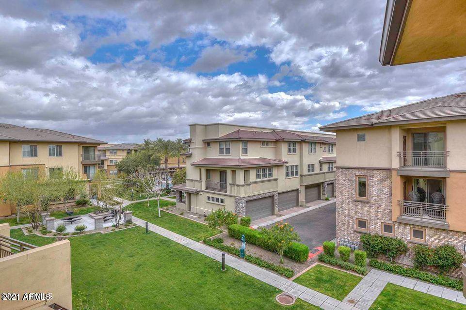 17850 North 68th Street, Unit 2063 Phoenix, AZ 85054 - Photo 7 of 23 a view of a house with a big yard plants and large trees