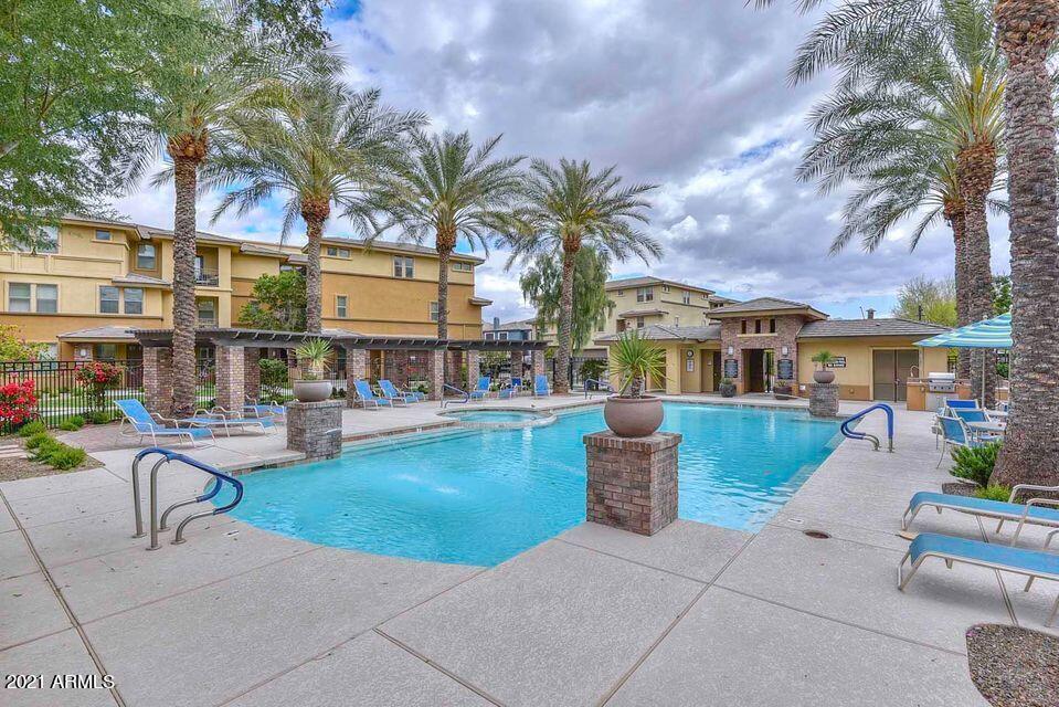 17850 North 68th Street, Unit 2063 Phoenix, AZ 85054 - Photo 8 of 23 a view of a patio with swimming pool table and chairs
