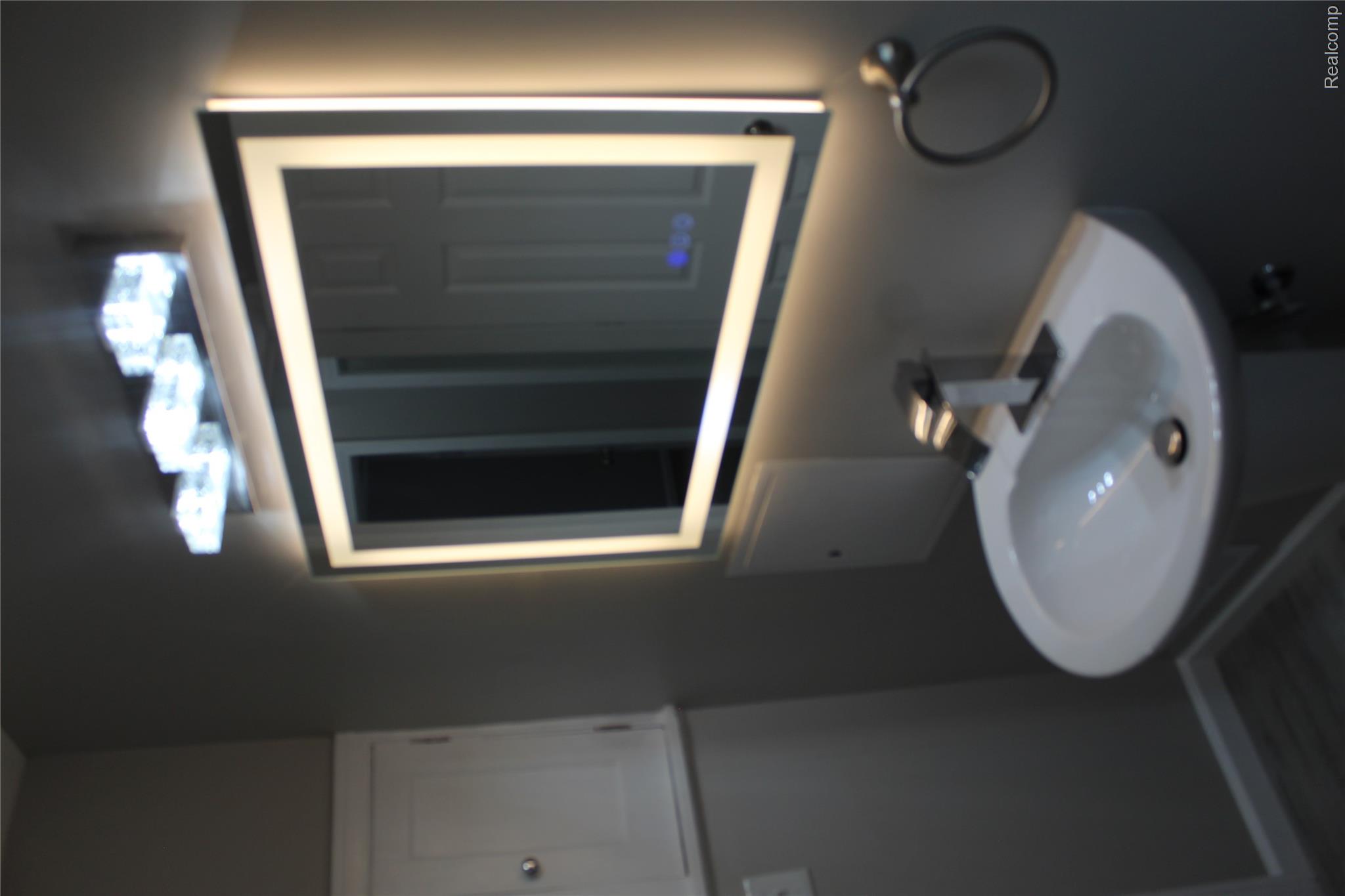 5543 Balfour Road Detroit, MI 48224 - Photo 13 of 54 Pedestal sink with modern faucet, illuminated mirror, and overhead lighting fixture