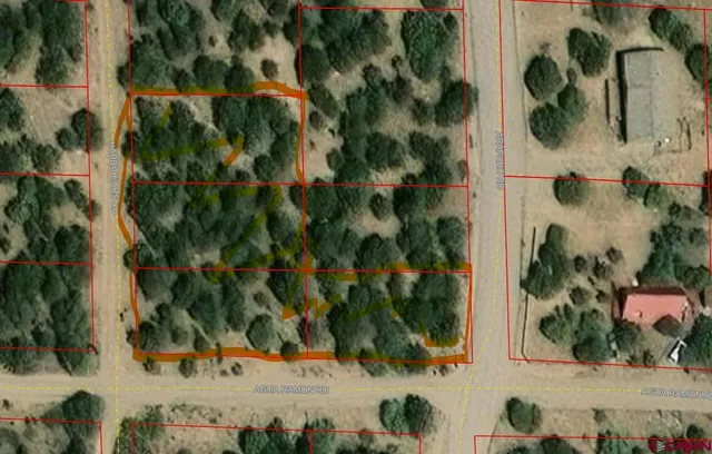 an aerial view of a residential houses with yard