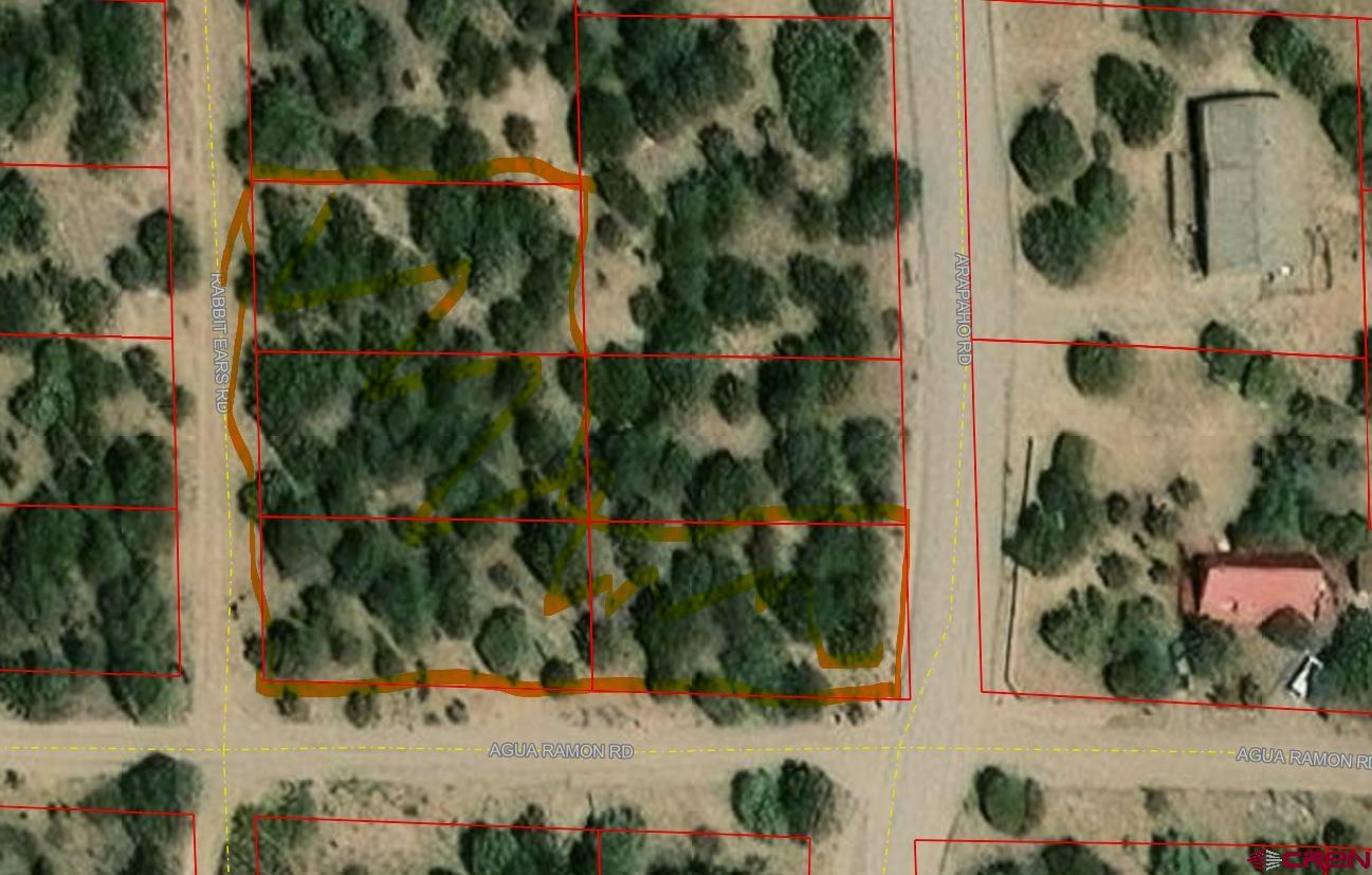 an aerial view of a residential houses with yard