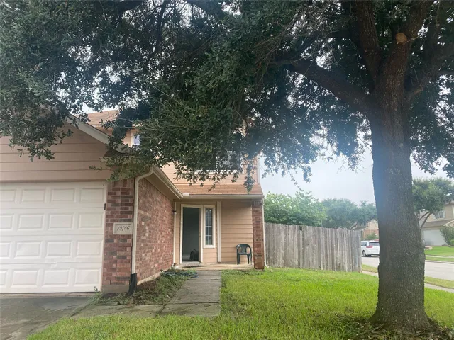 a front view of a house with a yard table and chairs