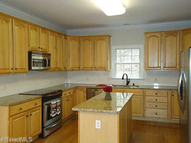 1807 Wild Fern Drive Oak Ridge, NC 27310 - Photo 7 of 16 Kitchen. Bright kitchen opens to family room with lots of cabinet space and center kitchen island. NEW GRANITE COUNTERS