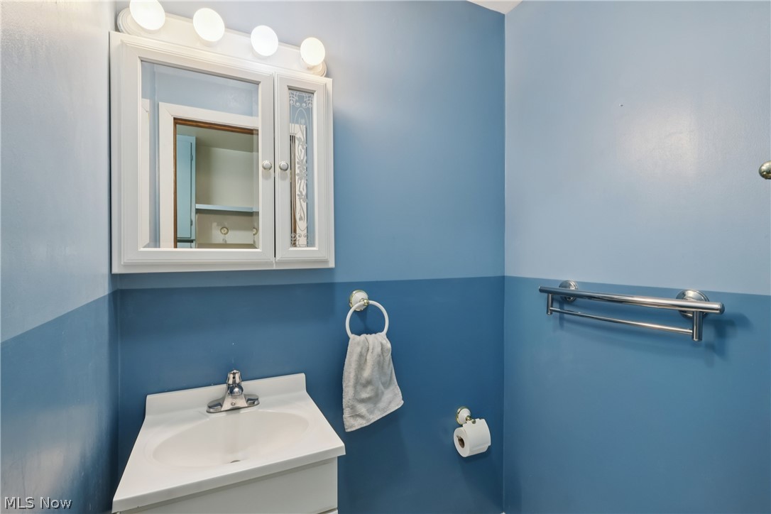 402 Yager Road Clinton, OH 44216 - Photo 17 of 38 First floor half bath with sink, vanity and commode