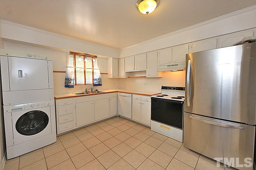 5141 Revere Road, Unit 29 Durham, NC 27713 - Photo 5 of 13 a kitchen with a refrigerator sink and cabinets