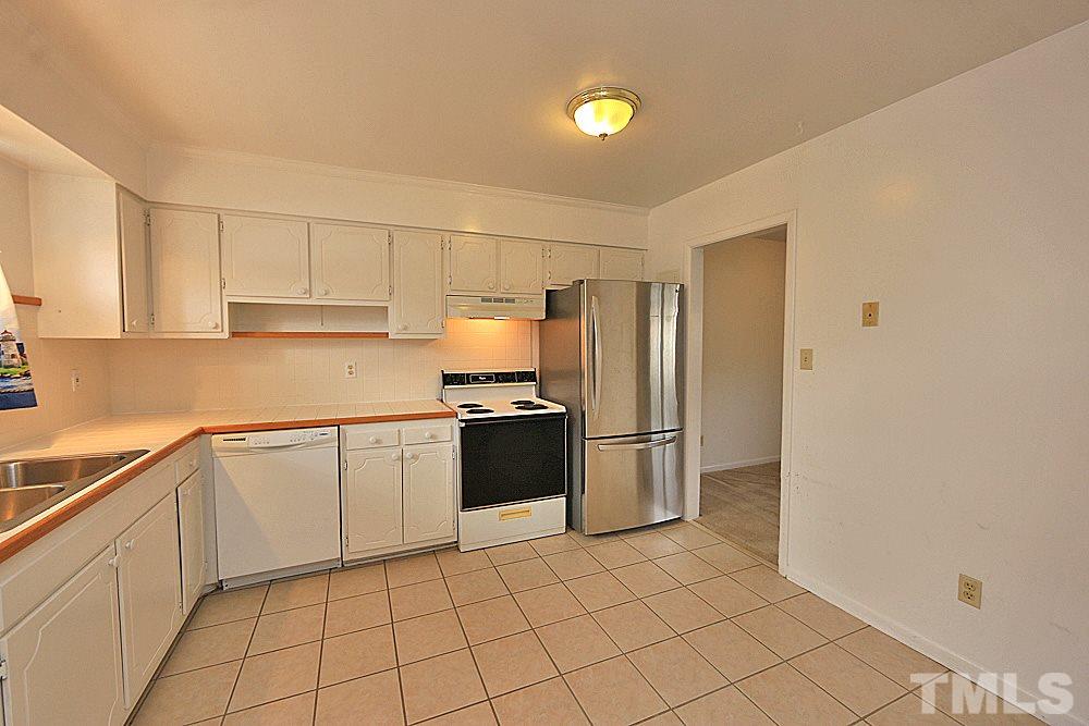 5141 Revere Road, Unit 29 Durham, NC 27713 - Photo 7 of 13 a kitchen with granite countertop a refrigerator and a sink