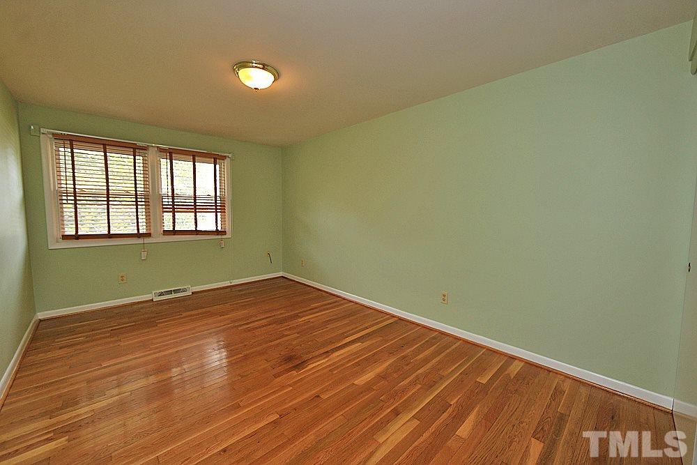 5141 Revere Road, Unit 29 Durham, NC 27713 - Photo 10 of 13 an empty room with wooden floor and windows