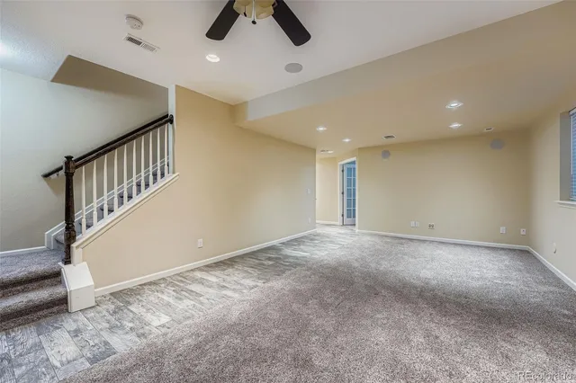 a view of an empty room with a ceiling fan