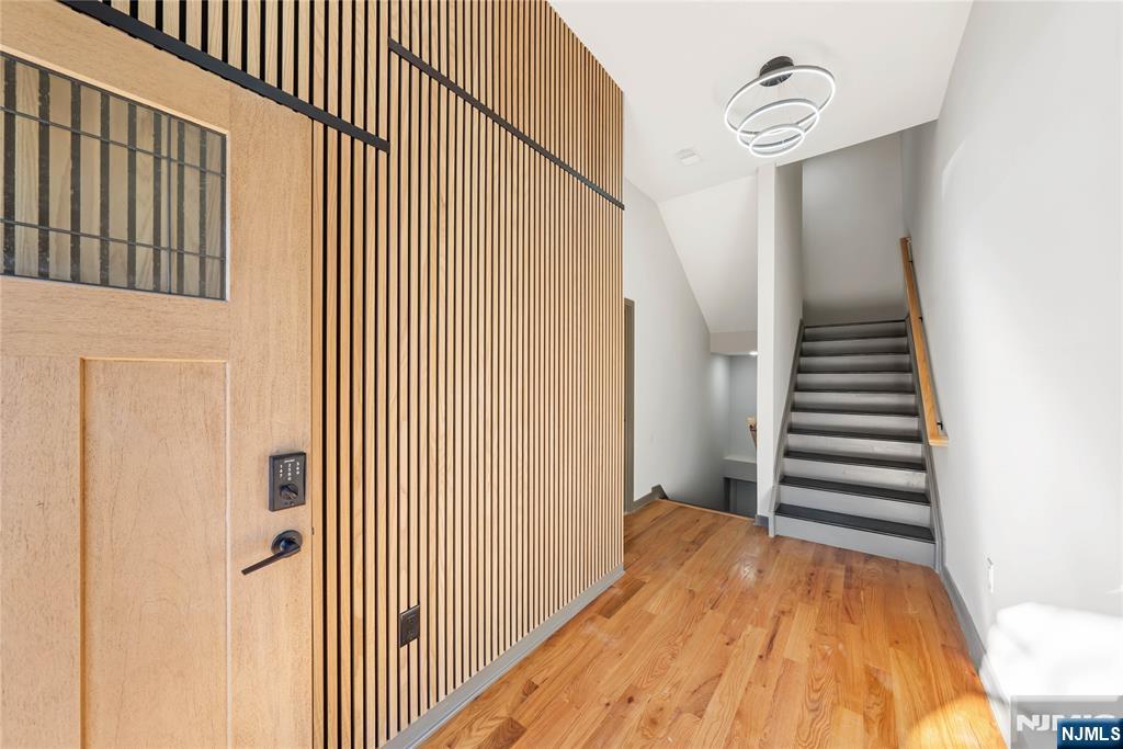 108 Fleming Avenue, Unit 2B Newark, NJ 07105 - Photo 14 of 21 a view of a hallway with stairs and wooden floor