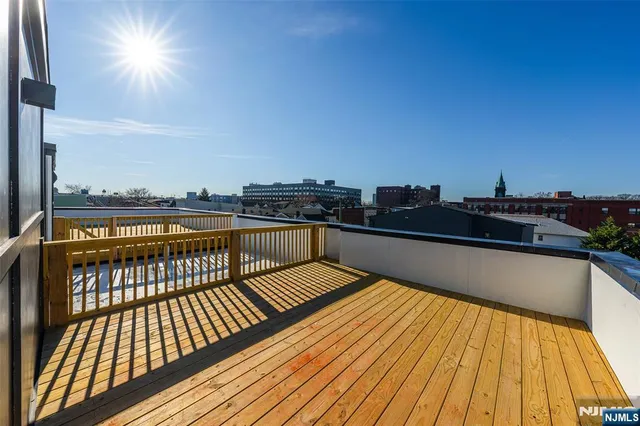 a view of balcony with wooden floor and city view