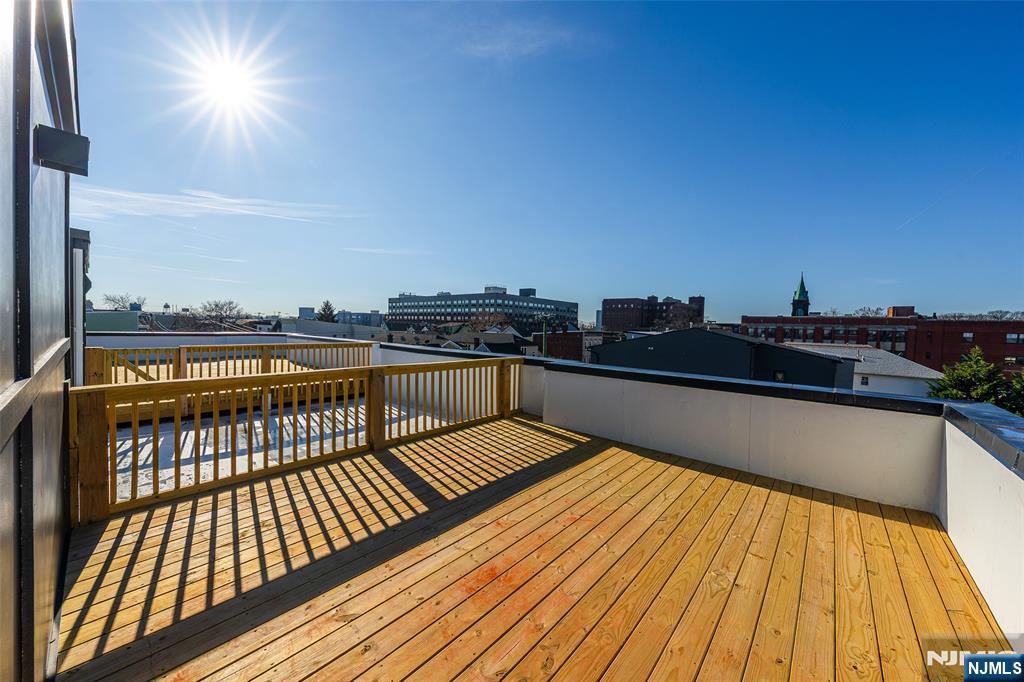 108 Fleming Avenue, Unit 2B Newark, NJ 07105 - Photo 15 of 21 a view of balcony with wooden floor and city view