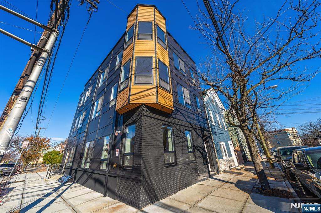 108 Fleming Avenue, Unit 2B Newark, NJ 07105 - Photo 20 of 21 a view of a house with a tree