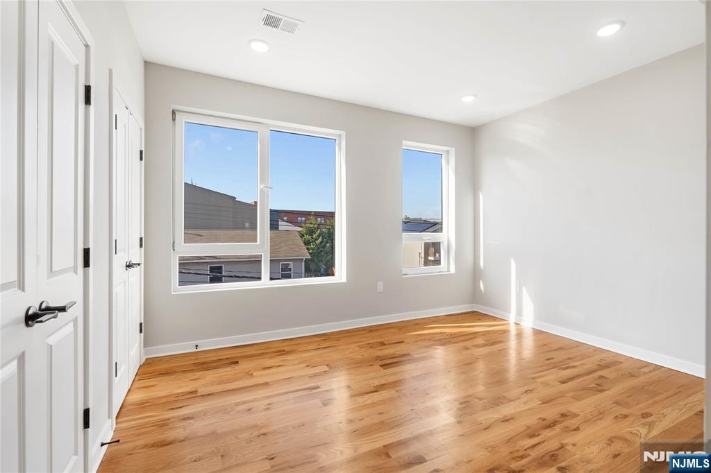 108 Fleming Avenue, Unit 2B Newark, NJ 07105 - Photo 6 of 21 a view of empty room with wooden floor and fan