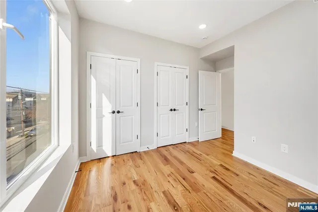 a view of a room with wooden floor and windows