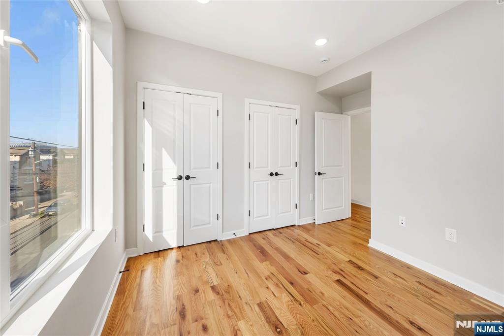 108 Fleming Avenue, Unit 2B Newark, NJ 07105 - Photo 10 of 21 a view of a room with wooden floor and windows