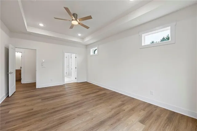a view of an empty room with wooden floor