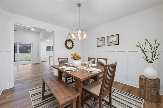 a view of a dining room with furniture wooden floor and a chandelier