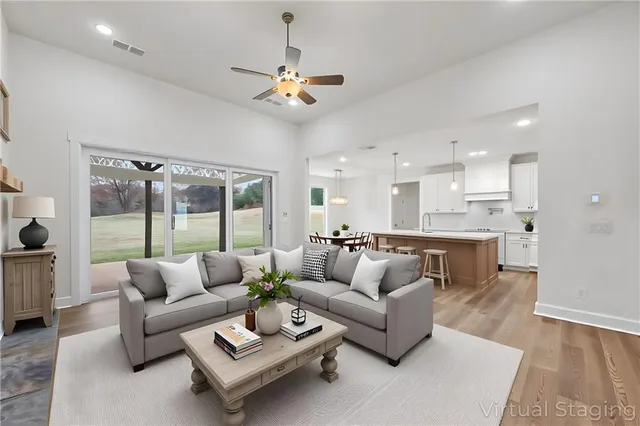 a living room with furniture and a large window