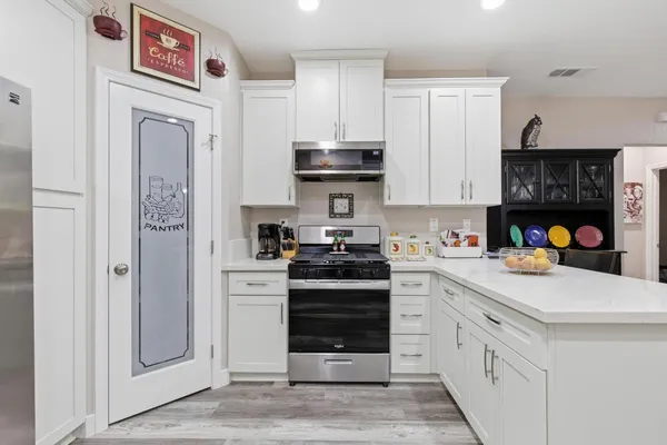 a kitchen with stainless steel appliances granite countertop a stove and a refrigerator