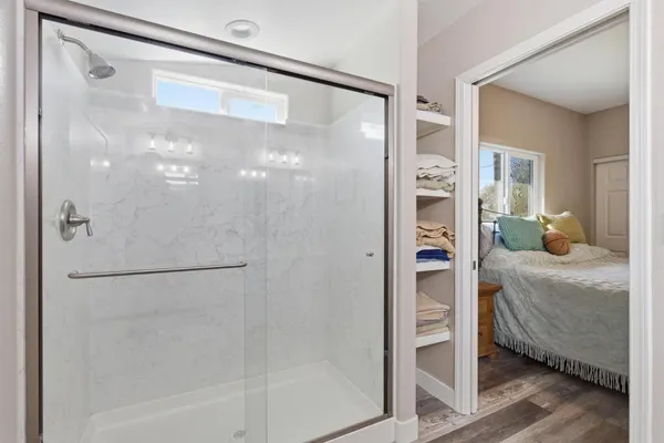 a bathroom with a glass shower door
