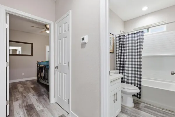 a bathroom with a toilet and a shower