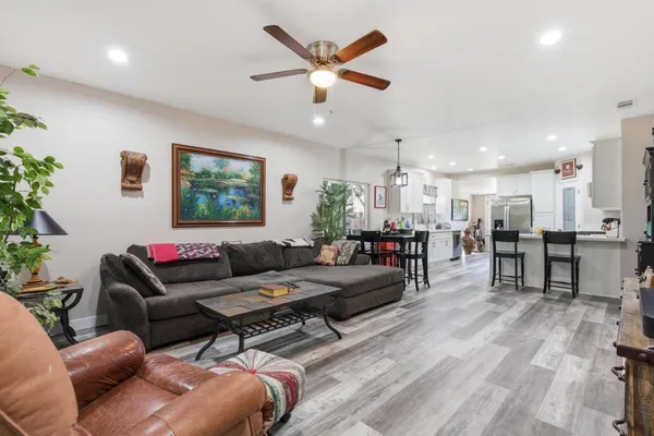 a living room with furniture and kitchen view