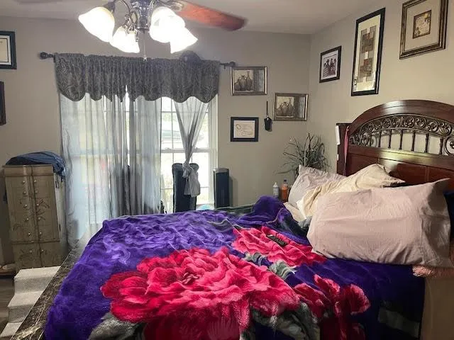 a bedroom with a bed and a mirror