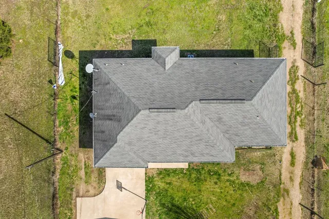 a aerial view of a house with a yard