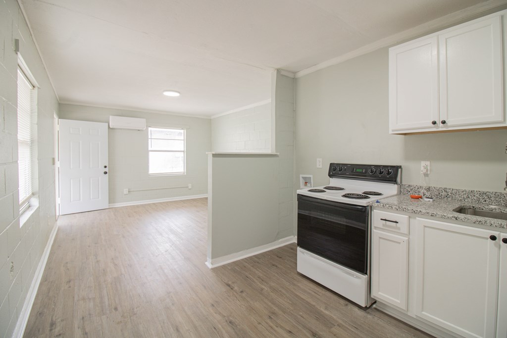 2408 16th Avenue, Unit A Columbus, GA 31901 - Photo 3 of 8 a kitchen with a stove and white cabinets