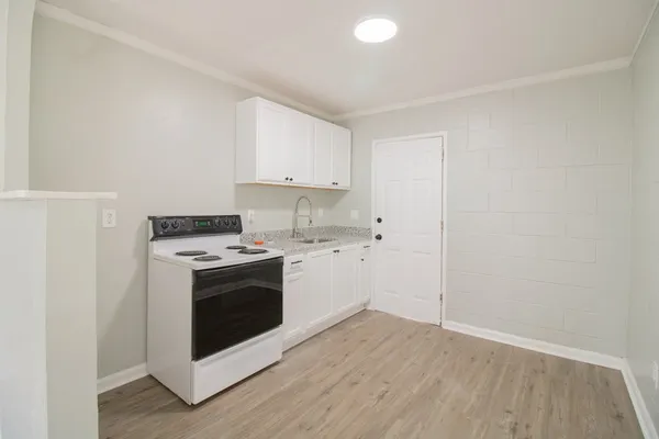a view of kitchen with wooden floor and electronic appliances