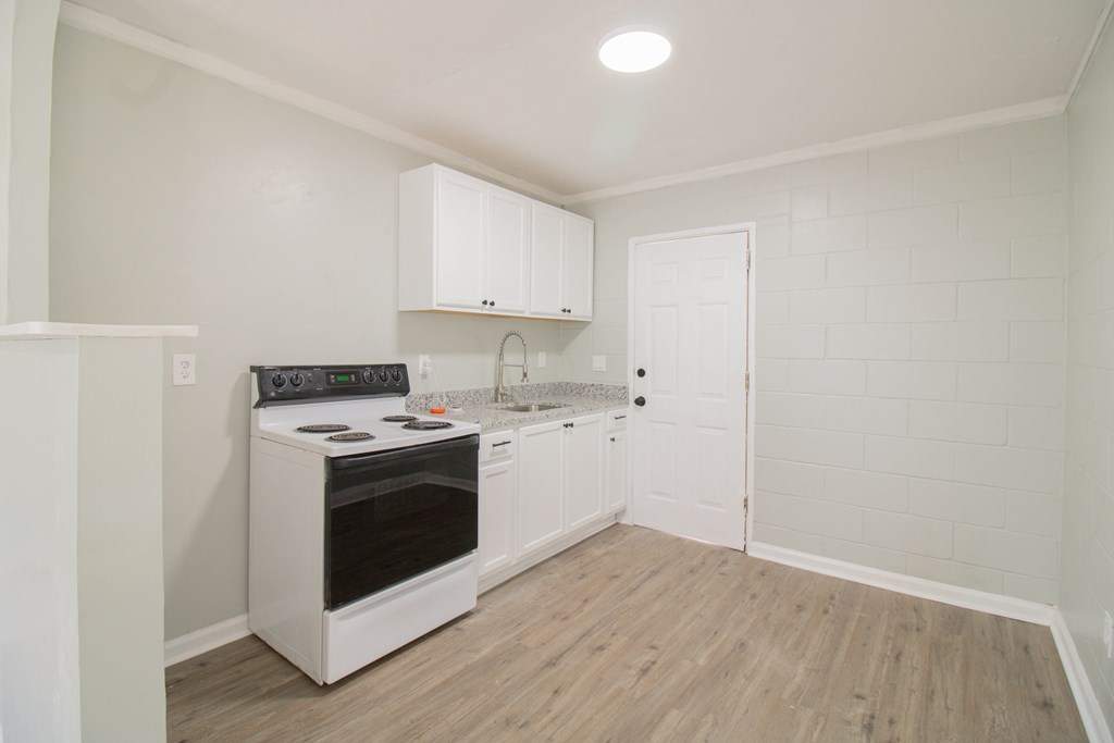 2408 16th Avenue, Unit A Columbus, GA 31901 - Photo 4 of 8 a view of kitchen with wooden floor and electronic appliances