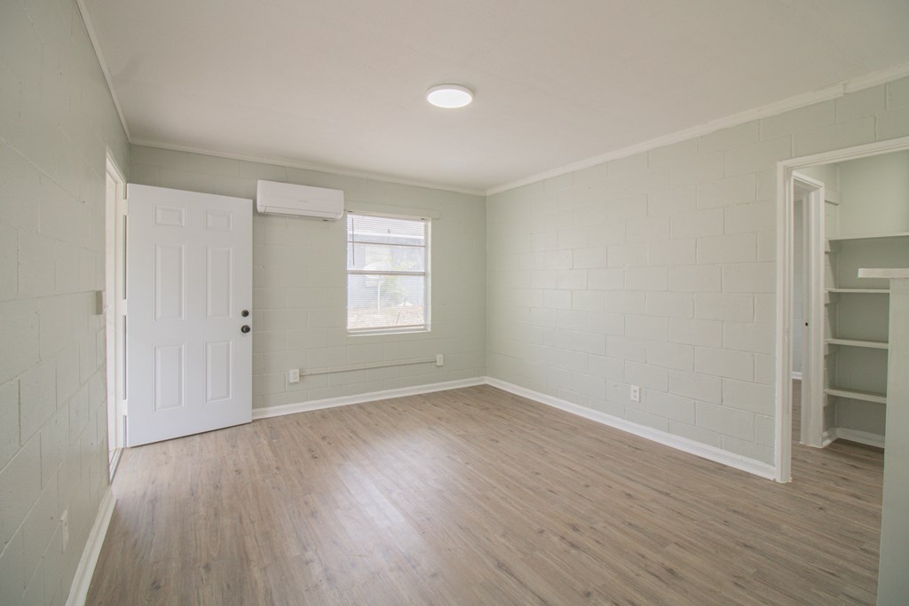 2408 16th Avenue, Unit A Columbus, GA 31901 - Photo 5 of 8 a view of an empty room with wooden floor and a window