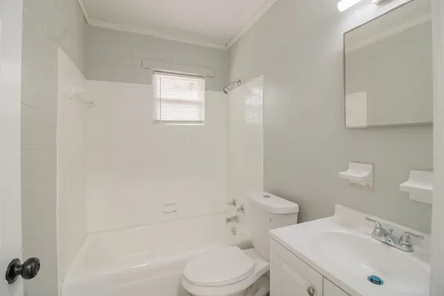 a white toilet sitting next to a bathroom sink