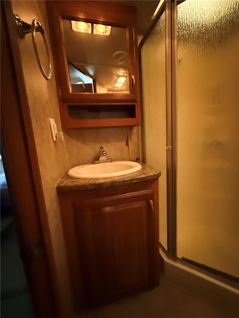 208 Reston Way Westminster, SC 29693 - Photo 14 of 32 This functional bathroom features a sleek vanity, convenient storage, and a practical shower for daily routines.