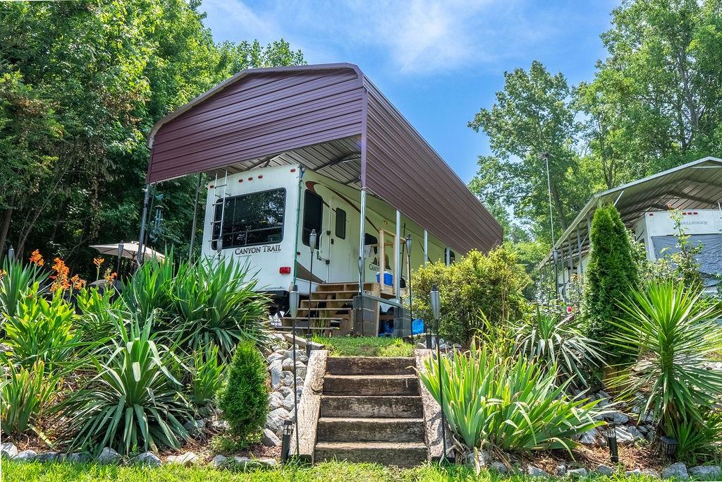 208 Reston Way Westminster, SC 29693 - Photo 16 of 32 This RV lot features mature landscaping and a permanent carport for ample shade and protection.