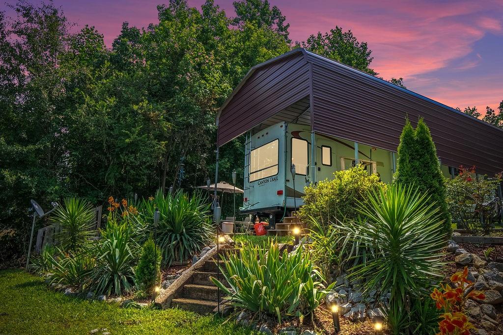 208 Reston Way Westminster, SC 29693 - Photo 2 of 32 This secluded property features a well-maintained yard and a dedicated RV parking structure.