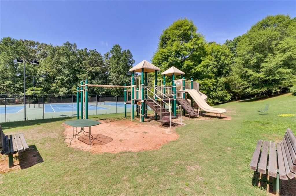 208 Reston Way Westminster, SC 29693 - Photo 28 of 32 This community recreation area features a vibrant playground and well-maintained tennis courts, perfect for active living.