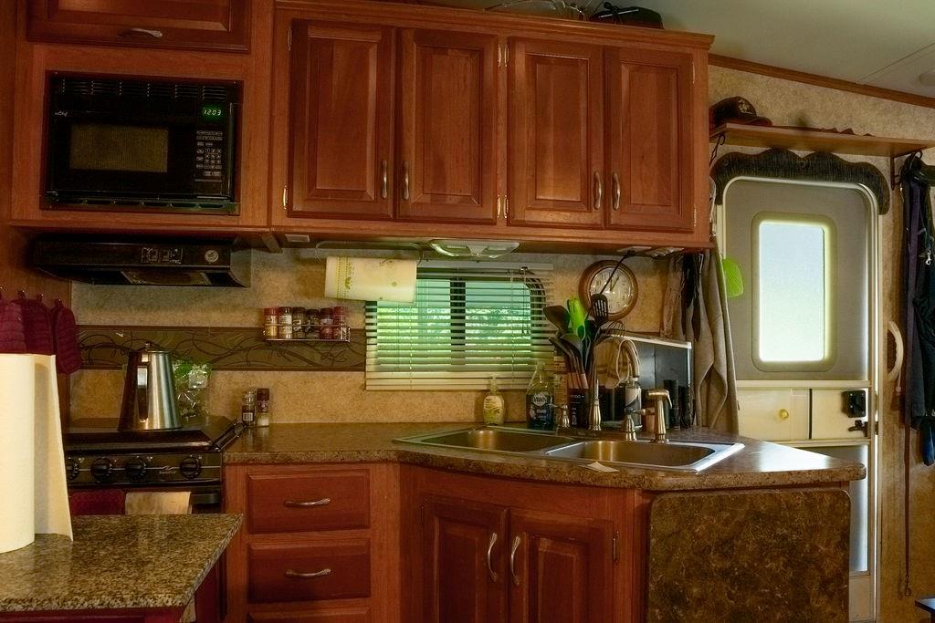 208 Reston Way Westminster, SC 29693 - Photo 8 of 32 This cozy kitchen features warm cabinetry and modern appliances, perfect for culinary endeavors.