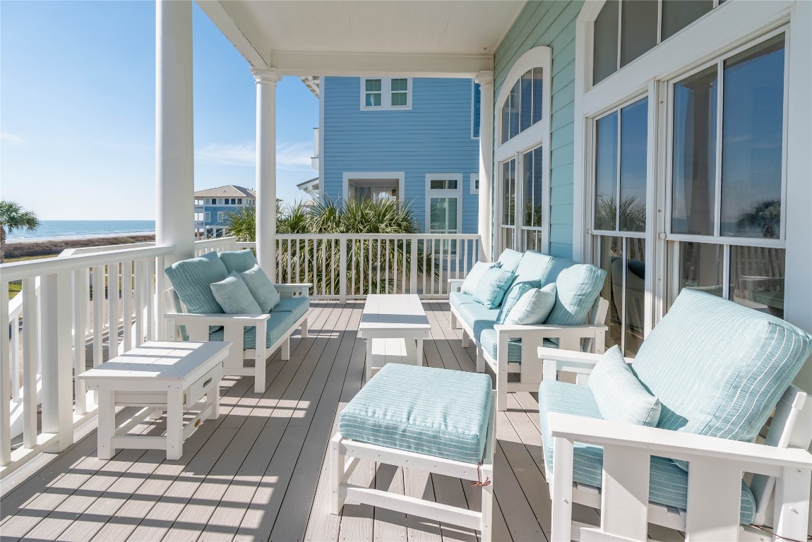11610 Beachside Galveston, TX 77554 - Photo 19 of 50 a view of a patio with couches chairs and wooden floor