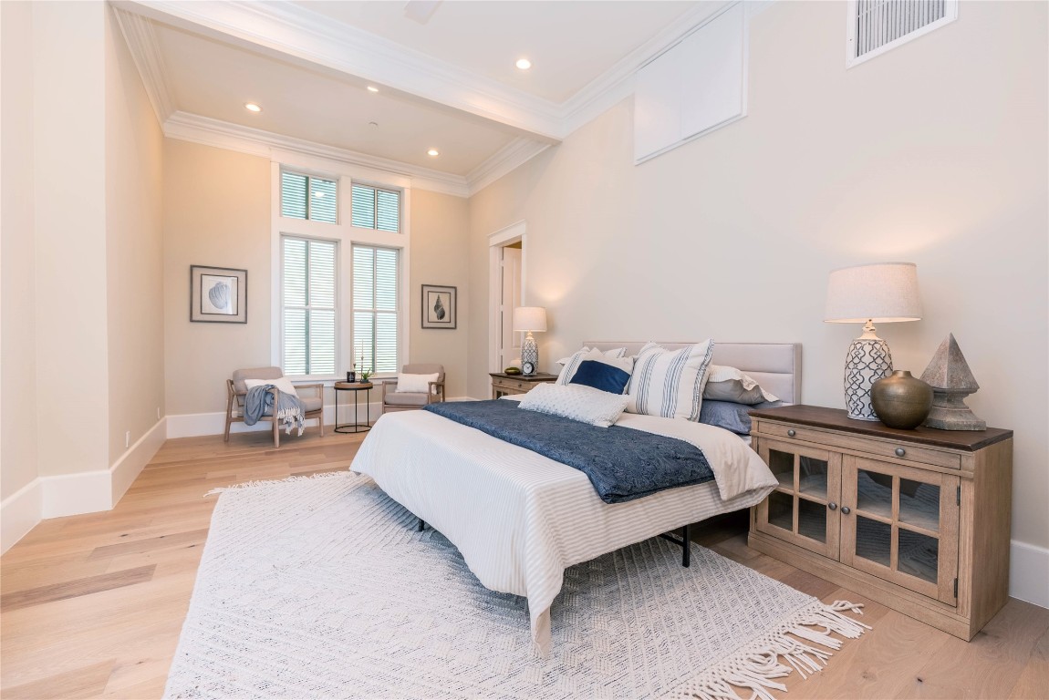 11610 Beachside Galveston, TX 77554 - Photo 23 of 50 a spacious bedroom with a bed and window